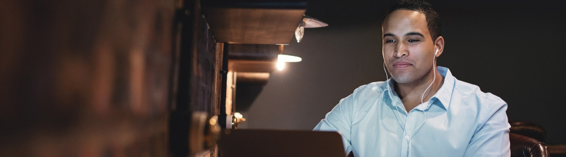 man with earphones on computer