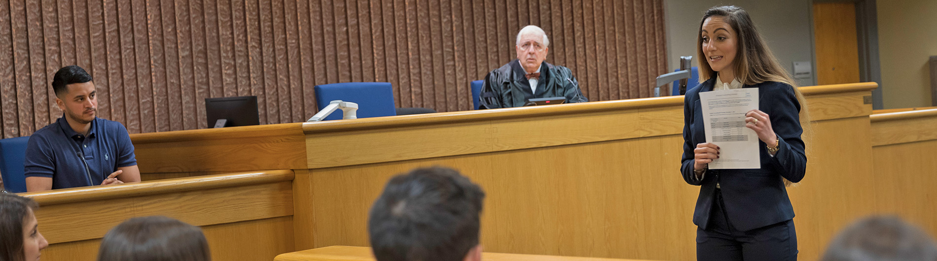 woman in business suit talking in courtroom