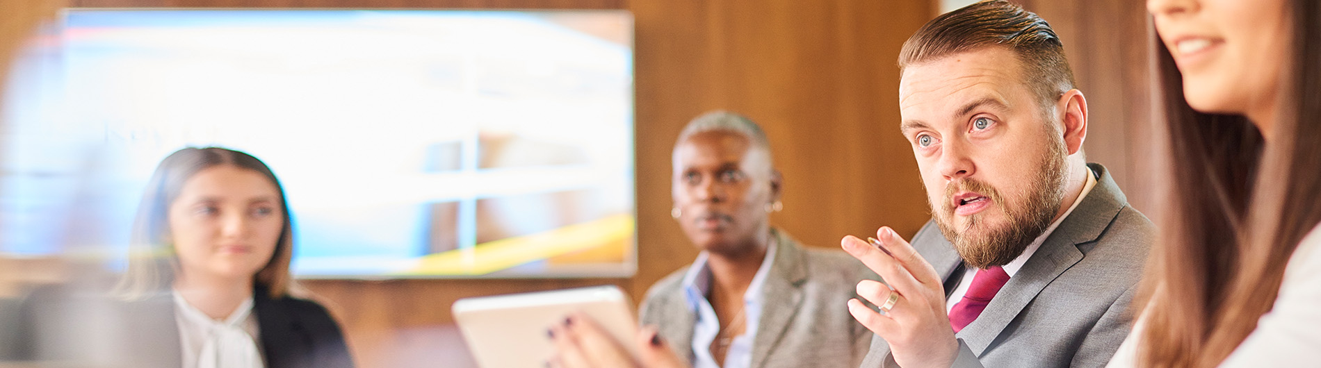 man in business attire making a point to someone not in the shot