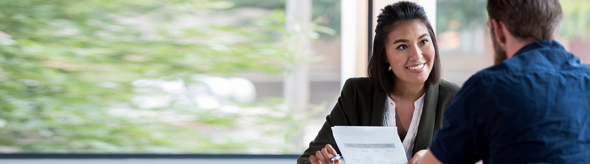 law student in professional attire laughing at something in a conversation