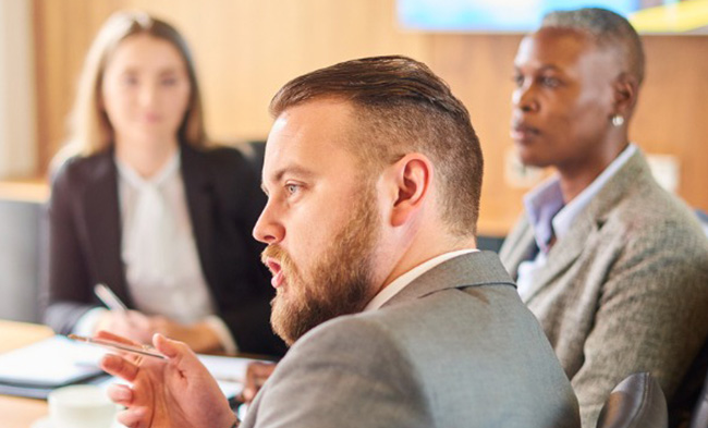 NSU law students seated around a table talking