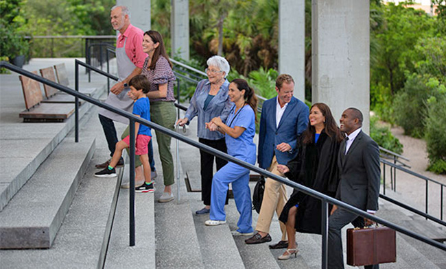 Diverse group of people walking up stairs