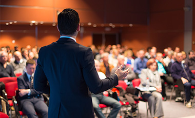 Man speaking to audience of people