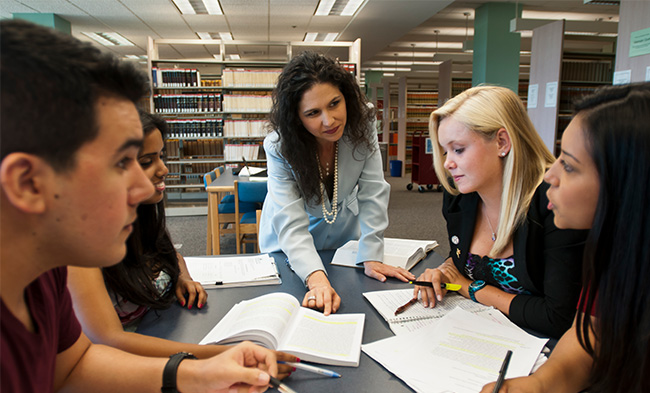 Diverse group of students in a working session at the library