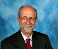 Portrait of a smiling man in a suit on a blue background