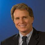 Portrait of a smiling man in a suit on a blue background