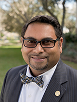 Portrait of a smiling man in a suit outdoors